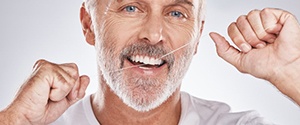 a man flossing his dental implants