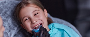a child being fitted for a customized mouthguard 