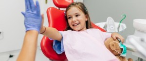 Child high-fives dentist