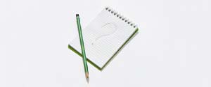 Green pencil and question mark on notepad
