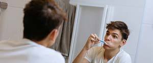 Man brushing teeth to prevent dental emergencies in Agawam