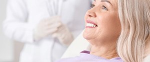 a patient smiling after receiving new dental implants