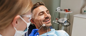 a patient smiling while getting a dental checkup