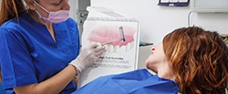 Dentist explaining how dental implants work to patient