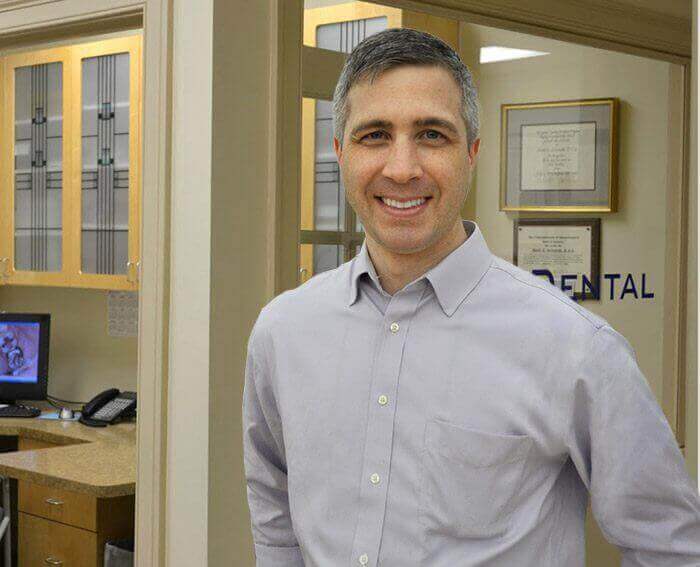 Dentist in Agawam smiling in dental office