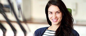 woman in blue sweater smiling