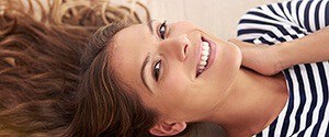 woman laying on floor smiling