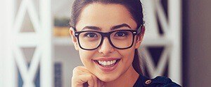 woman with glasses smiling