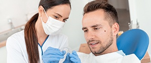 Dental hygienist shows patient occlusal splint