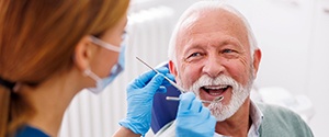Man smiles at dental hygienist