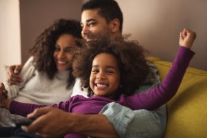 family embracing on couch