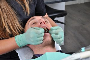 Man receiving oral cancer screening