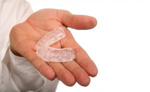 Dentist presenting a mouthguard