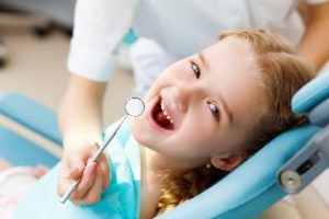 Smiling child in the dental chair.