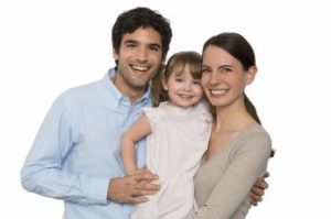 Happy family smiling at camera