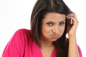 Woman rinsing her mouth at her dentist.