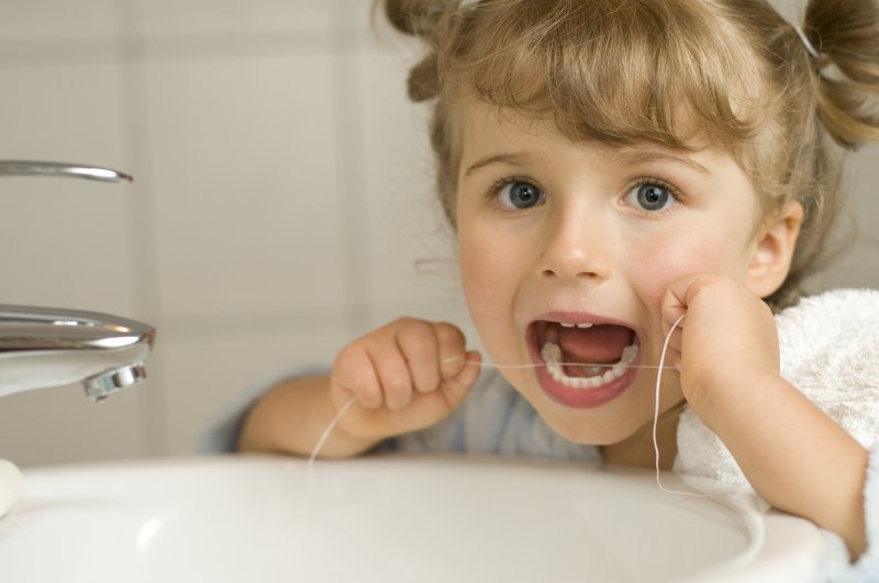 Little girl flossing