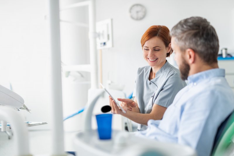 a patient speaking with a cosmetic dentist in Agawam