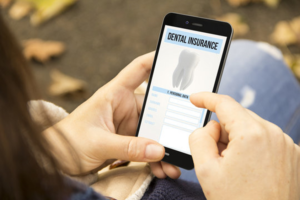 a patient checking her dental insurance coverage on her smartphone
