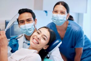 Dental patient with dental team in background