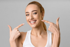 Woman pointing at her bright smile