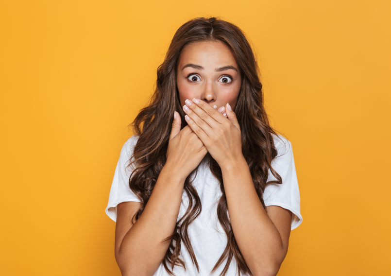 Woman covering mouth with hands